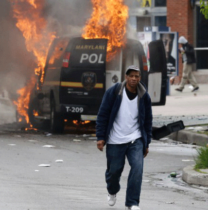 Protesters in Baltimore set fire to police vehicles
